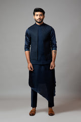 Navy blue Nehru jacket with Honeycomb pattern embroidery highlighted with panel detailing, paired with adrape kurta set
