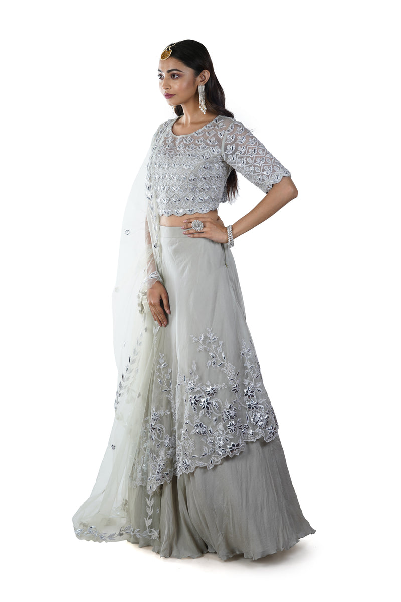 Light Green Floral Embroidered Blouse with an Asymmetrically Layered Lehenga paired with a Dupatta