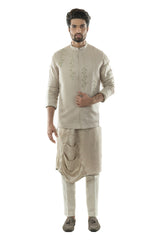 An Oyester Grey Nehru With Minimal Zari And Silk Thread Hand Embroidery. Paired With A Drape Kurta and Narrow Fitted Pant Pajama.